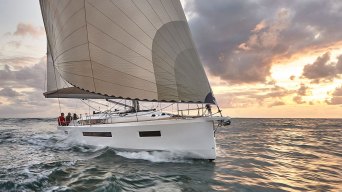 Large sailboat sailing through bay during late afternoon