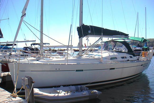 Side view of Summerland sailboat sitting in water at harbor